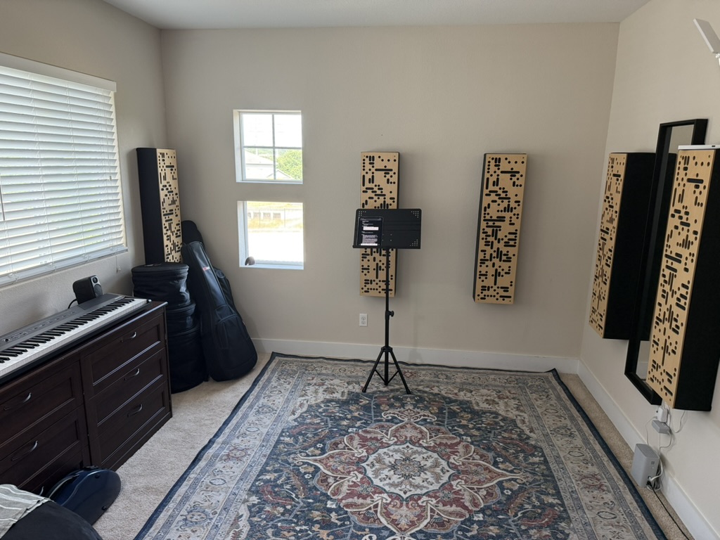 Another angle of the dedicated North Austin teaching loft with music stand, acoustic treatment, keyboard, and rug