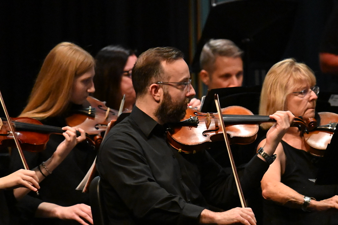 David Price performing violin in an orchestra
