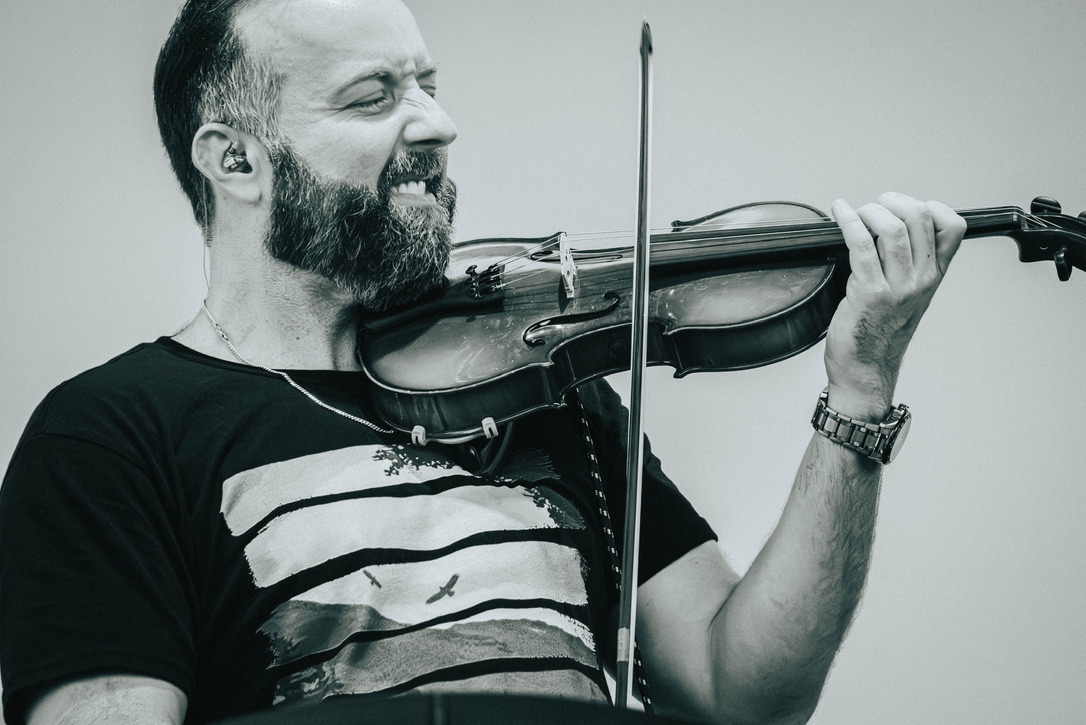 David Price performing violin live on stage