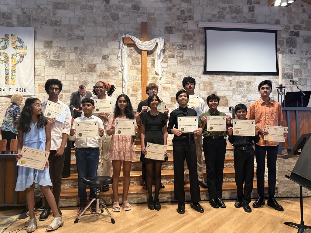 David Price Music students at a recent studio recital holding certificates and awards