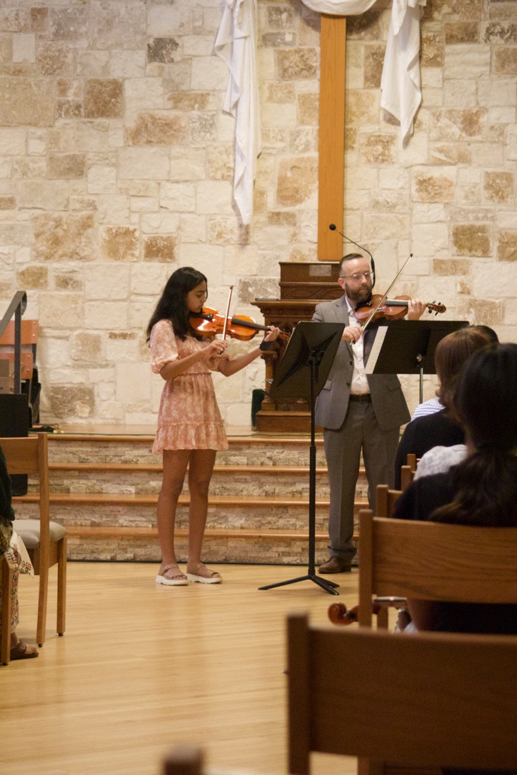 David Price performing violin alongside a student at a recital