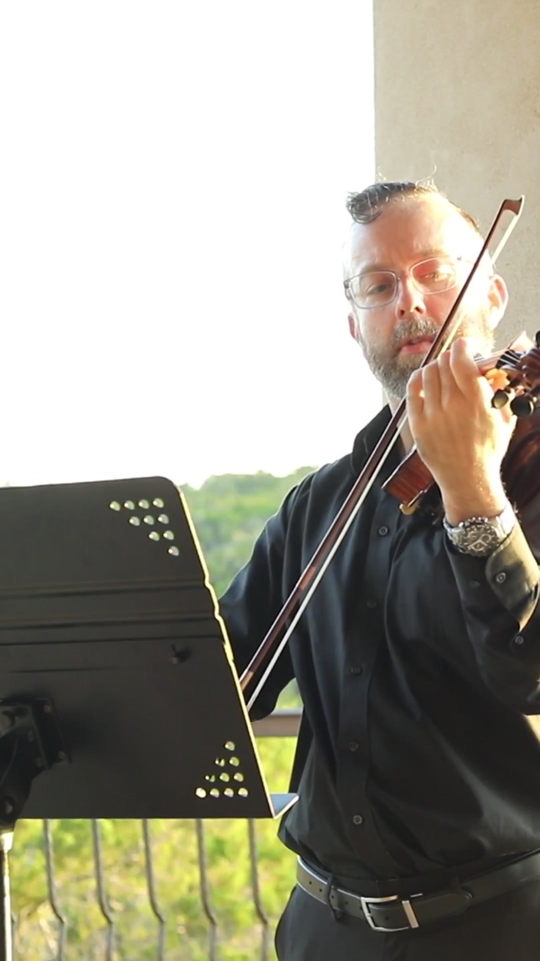 Close view of David Price performing violin at a wedding