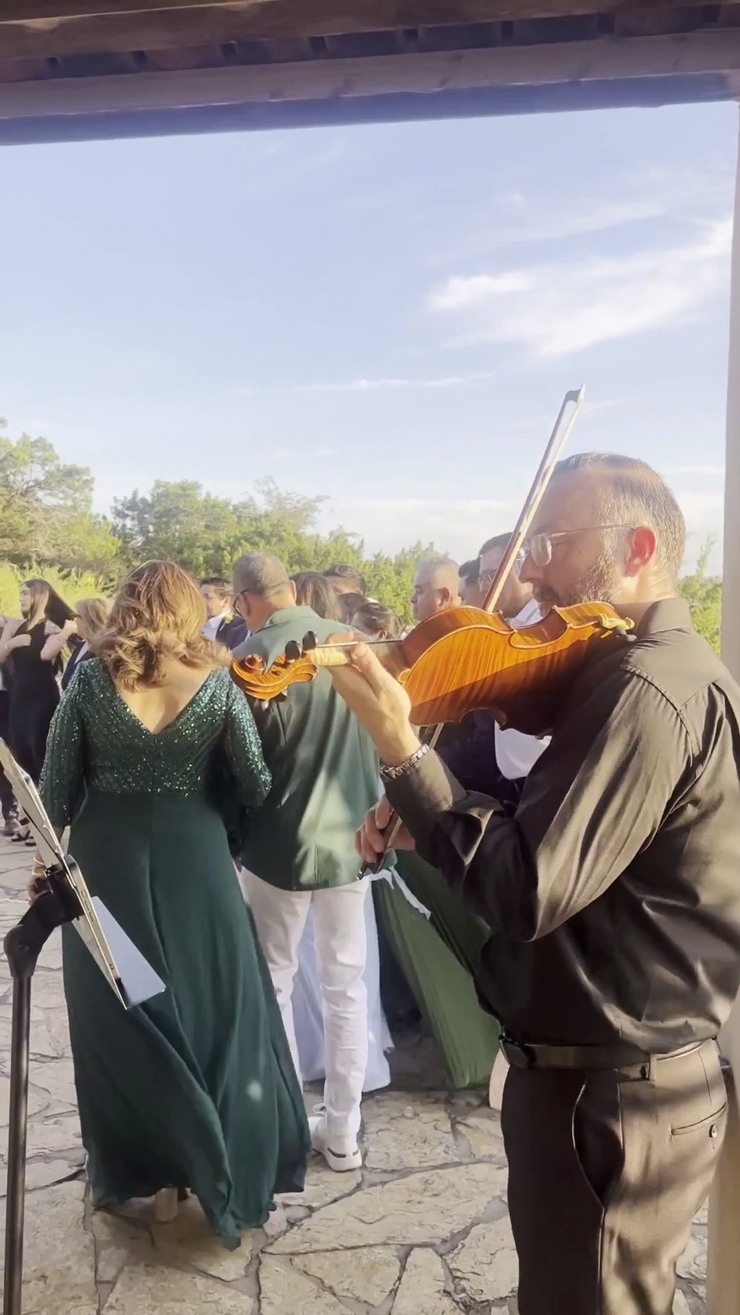 David Price playing amplified violin during a wedding celebration