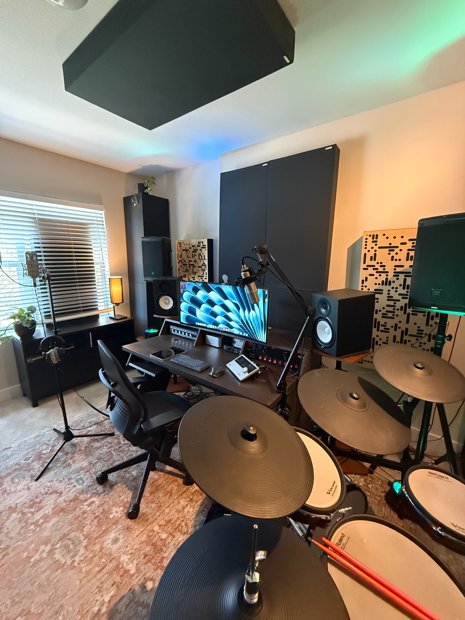 Wide view of David Price's recording and production studio with acoustic treatment, microphones, monitoring, and electronic drums